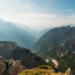 Vista panorámica de montañas y valles iluminados por el sol