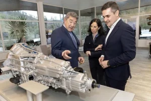Tres personas observan un motor en la planta de Schaeffler en Elgoibar.