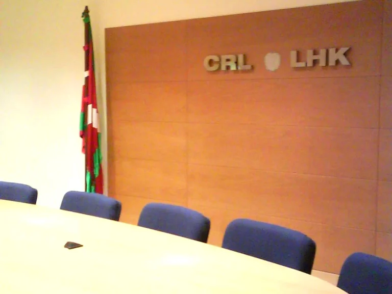 Sala de reuniones con bandera vasca y mesa ovalada