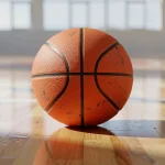 Balón de baloncesto sobre una cancha de madera iluminada