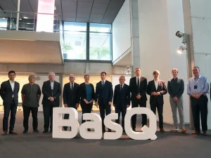 Grupo de personas posando junto al letrero BasQ en un evento