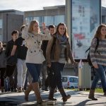 Grupo de estudiantes caminando por el campus universitario