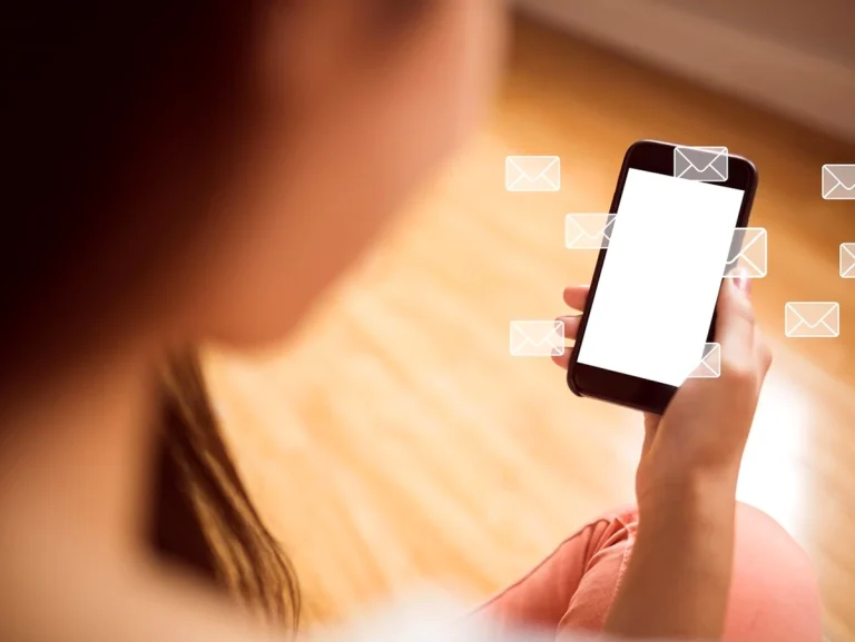 Mujer revisando su teléfono móvil con notificaciones de correo