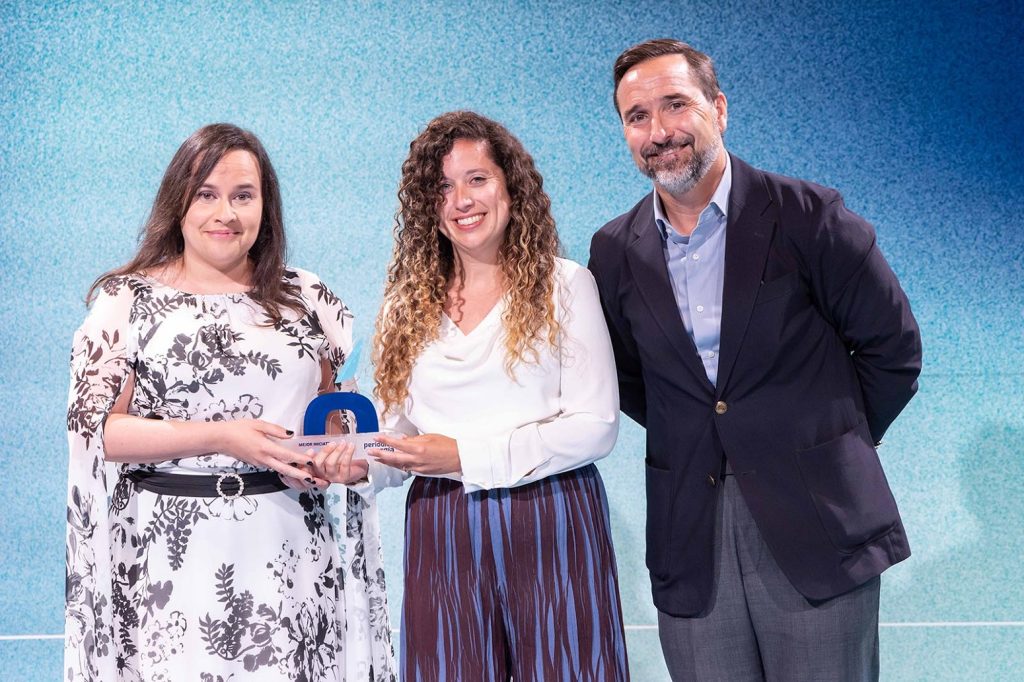Tres personas posan con un premio en un evento de energía