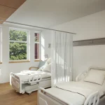 Habitación del pabellón Ampuero con camas y luz natural